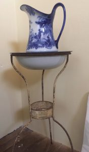 A photo of Clara's bedroom with a porcelain jug on a stand