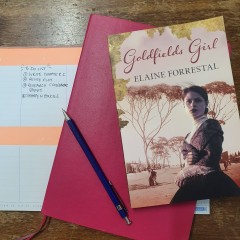 Photo of Elaine Forrestal's desk with a copy of Goldfields Girl and notes
