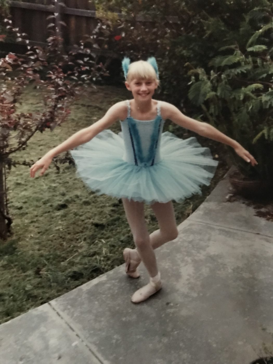 Image a young girl dressed in a blue ballerina outfit