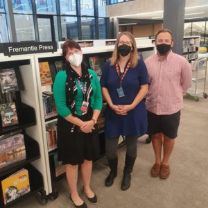 librarians Margot Kopsen, Jayne Cleave and Joel Evans in front of the Fremantle Press collection at Fremantle Library