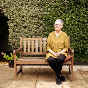 Wendy Davis sitting on a bench