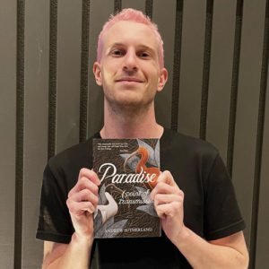 Andrew Sutherland holding a copy of Paradise (point of Transmission)